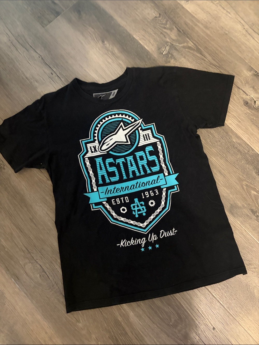 Astars Black Tee with Teal Badge Graphic